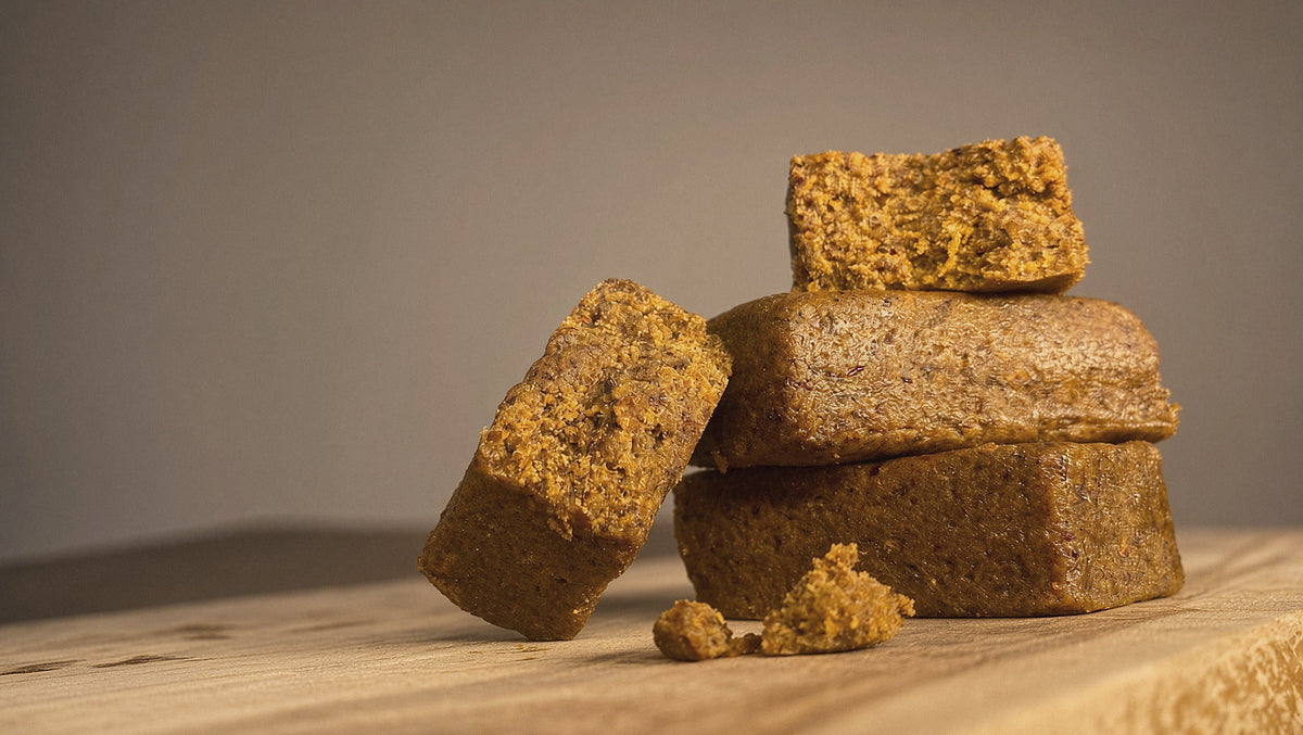 BIVI beef pemmican bars stacked on a wooden board